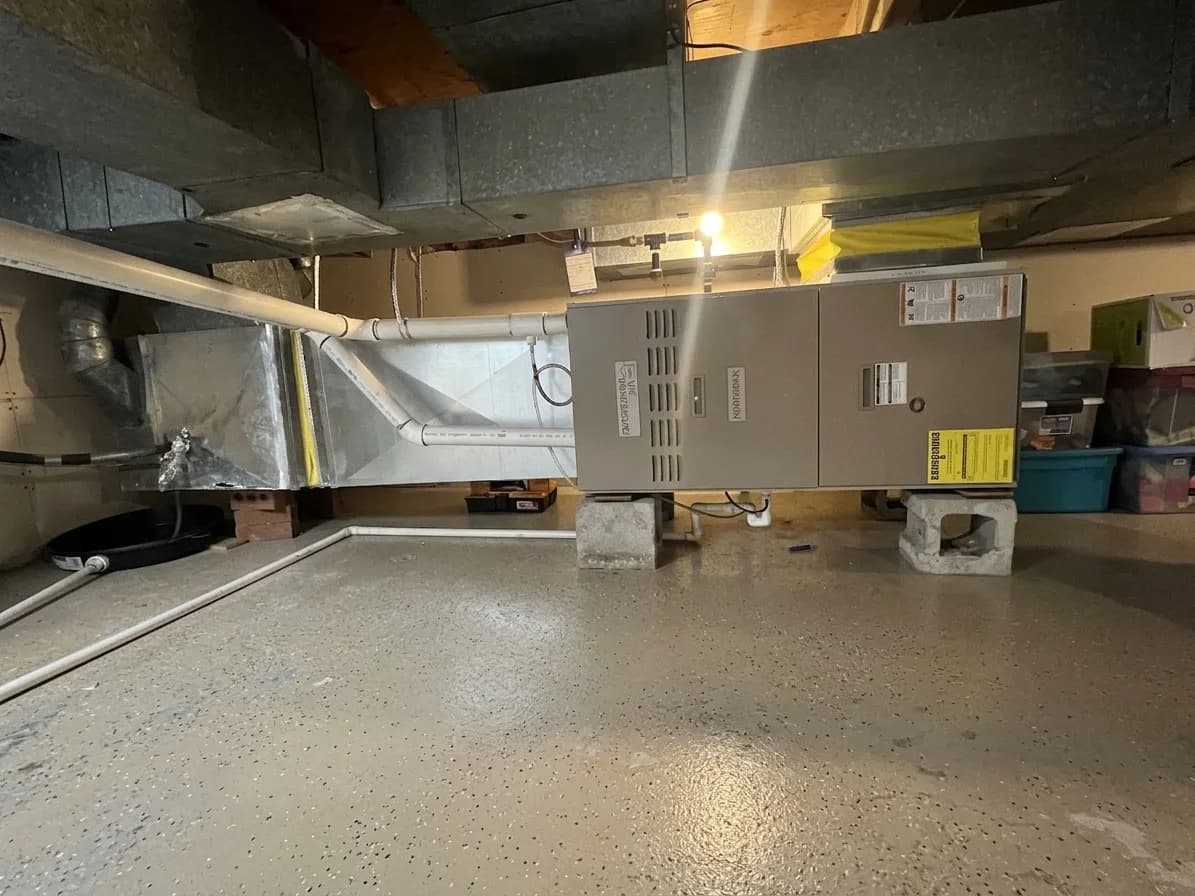 Furnace installed in a crawl space with insulated ductwork.