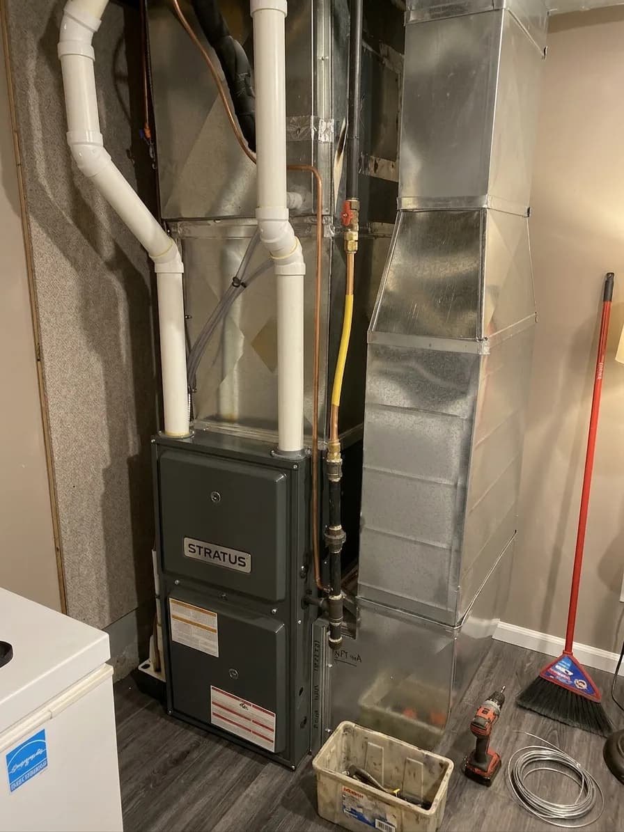 High-efficiency residential furnace installed in a utility area.