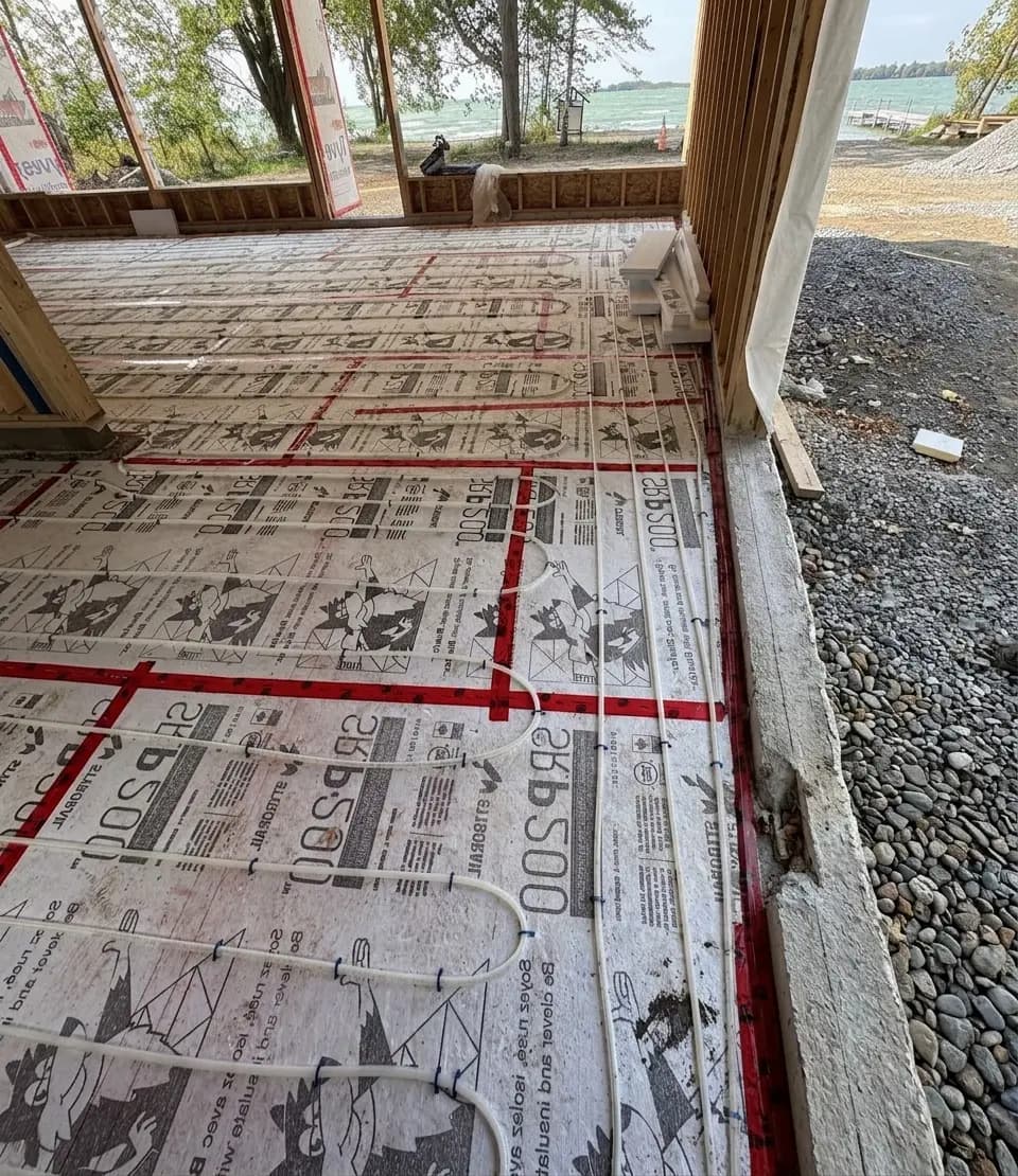 PEX radiant floor heating tubing laid out before pour.