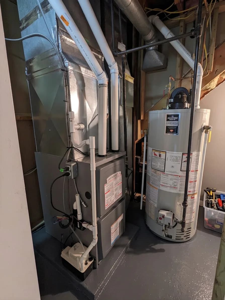 Tidy mechanical room with water heater and high-efficiency furnace side by side.